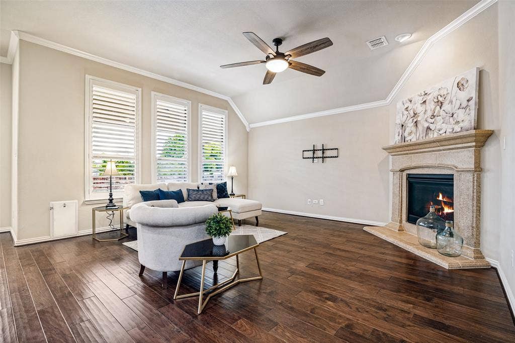 8303 Lake Valley Court, Rowlett, TX 75089 living room with gas fireplace overlooks back yard