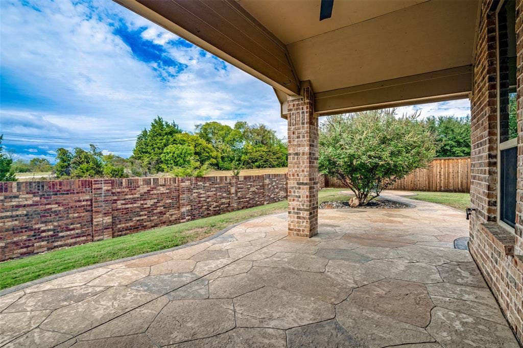 8303 Lake Valley Court, Rowlett, TX 75089 Gorgeous covered patio just off of living room with stamped concrete back patio which extends to fire pit area
