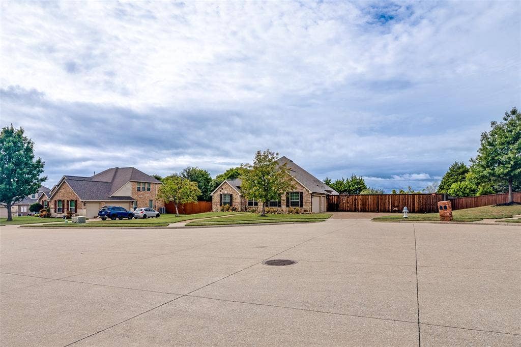 8303 Lake Valley Court, Rowlett, TX 75089 Home is located on a large cul de sac lot with large aggregate driveway