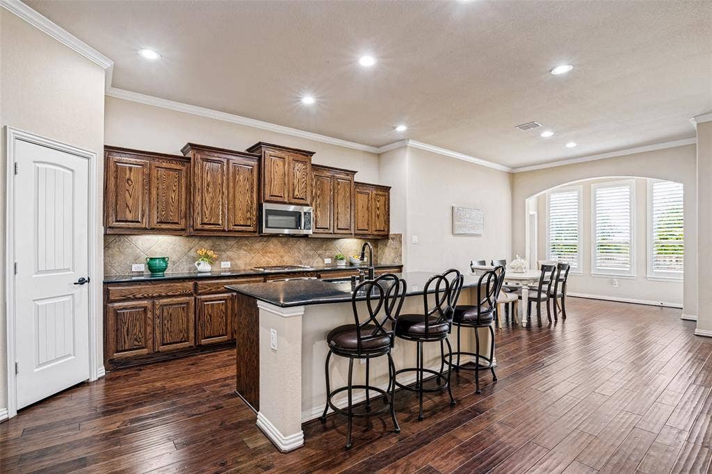 8303 Lake Valley Court, Rowlett, TX 75089 Stunning oversized Kitchen has Great Island, stainless appliances, including gas cooktop.