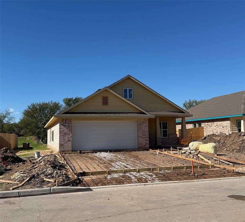 415 Conway, Lacy Lakeview, TX 76705 Exterior elevation featuring lap siding, brick masonry, a gabled roofline, and an attached two-car garage