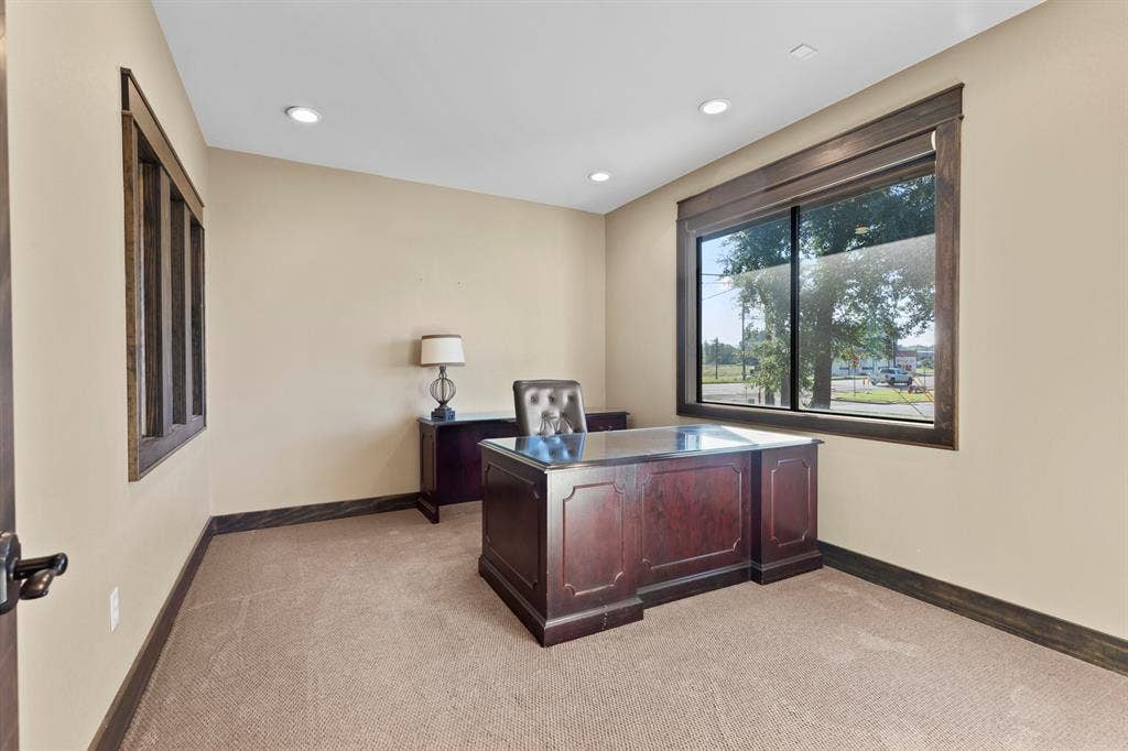 700 N Main Street, Lindale, TX 75771 Room featuring neutral wall tones, plush carpeting, recessed lighting, and large windows framed in dark-stained wood trim
