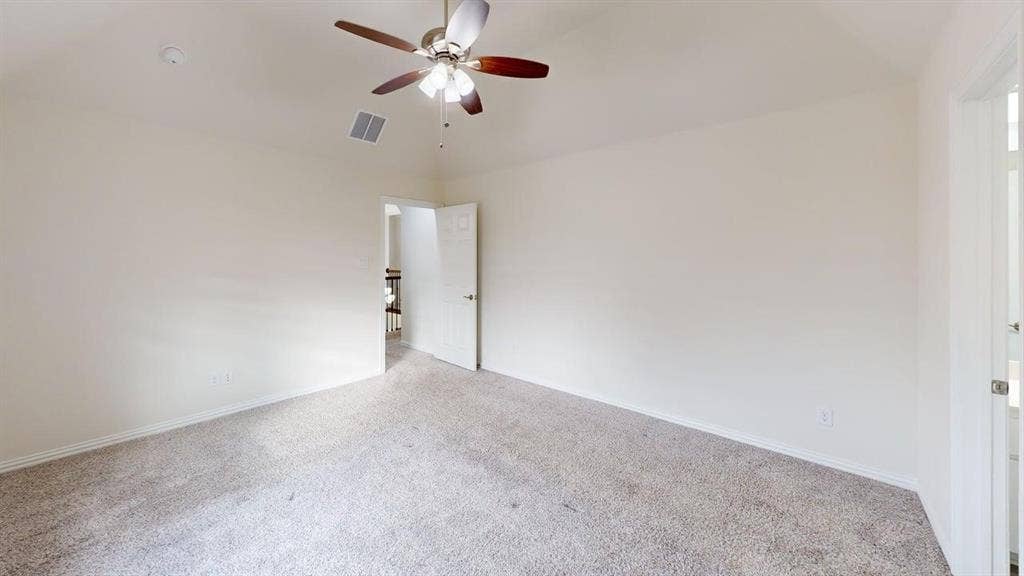 14518 Shady Grove Lane, Frisco, TX 75035 Vaulted ceilings with a multi-blade ceiling fan, neutral wall tones, and carpeted flooring