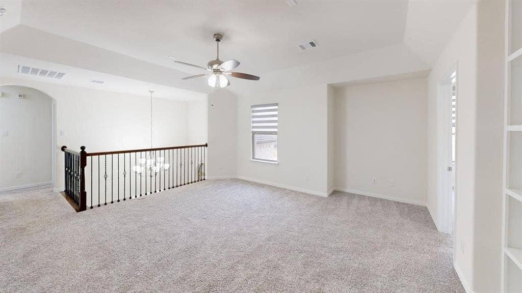 14518 Shady Grove Lane, Frisco, TX 75035 Vaulted ceiling, iron baluster railing, carpeted flooring, built-in shelving, and ceiling fan