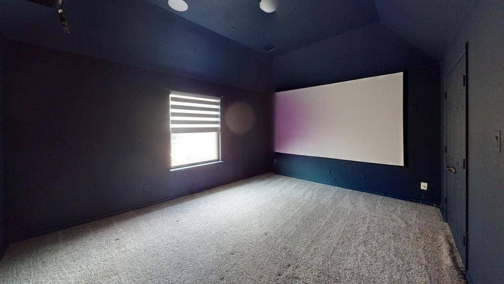 14518 Shady Grove Lane, Frisco, TX 75035 Vaulted ceiling, wall-mounted projection screen, neutral carpeting, and a single window with integrated adjustable blind