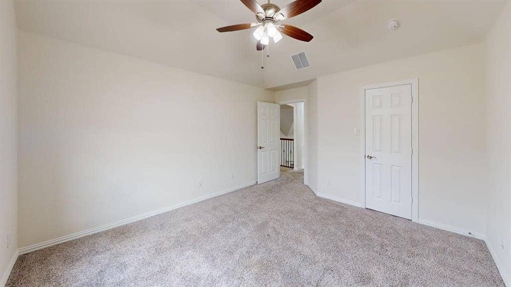 14518 Shady Grove Lane, Frisco, TX 75035 Neutral-toned room featuring a vaulted ceiling, carpeting, and a ceiling fan with integrated lighting