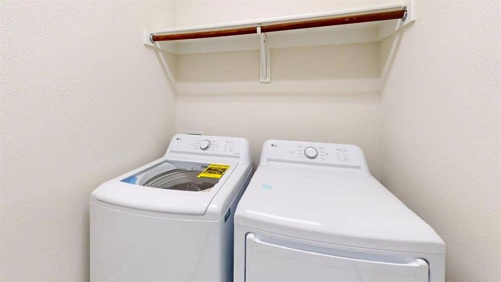 14518 Shady Grove Lane, Frisco, TX 75035 Dedicated laundry area featuring a built-in wooden hanging rod and overhead white shelving