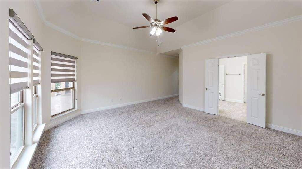 14518 Shady Grove Lane, Frisco, TX 75035 Vaulted ceiling featuring a central multi-blade ceiling fan, neutral wall-to-wall carpeting, and double doors opening to a separate room with wood-finish flooring