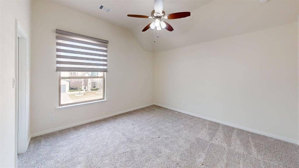 14518 Shady Grove Lane, Frisco, TX 75035 Vaulted ceiling featuring a ceiling fan with integrated lighting, neutral carpeting, and a dual-shade window treatment