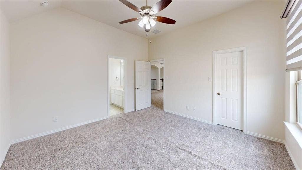 14518 Shady Grove Lane, Frisco, TX 75035 Vaulted ceilings, neutral wall color, multi-blade ceiling fan with integrated lighting, wall-to-wall carpeting, and six-panel interior doors