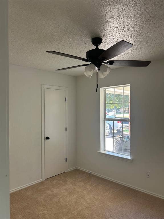 1114 Idlewood Drive, Waco, TX 76705 Neutral interior featuring wall-to-wall carpeting, a multi-blade ceiling fan with integrated lighting, and a single-hung window with a grille pattern