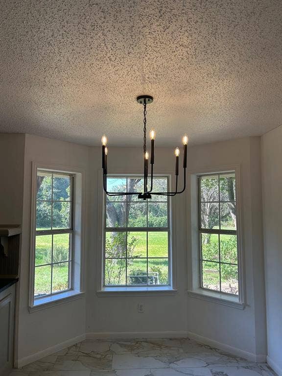 1114 Idlewood Drive, Waco, TX 76705 Bay window featuring multi-pane glass, matte black six-light chandelier, and stone-finish flooring