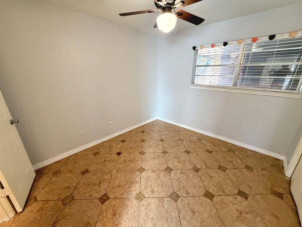 2701 Northcrest Drive, Plano, TX 75075 Room featuring decorative tile flooring, ceiling fan with integrated light fixture, and horizontal blind window treatment