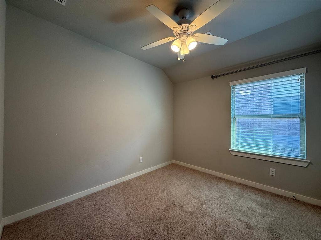 1702 Sagebrush Trail, Wylie, TX 75098 Room featuring vaulted ceilings, carpeted flooring, neutral wall paint, a multi-blade ceiling fan with integrated lighting, and a window with horizontal blinds