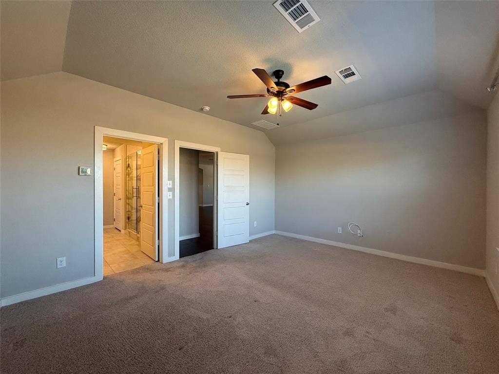 1702 Sagebrush Trail, Wylie, TX 75098 Room featuring vaulted ceilings, neutral carpeting, and a multi-light ceiling fan