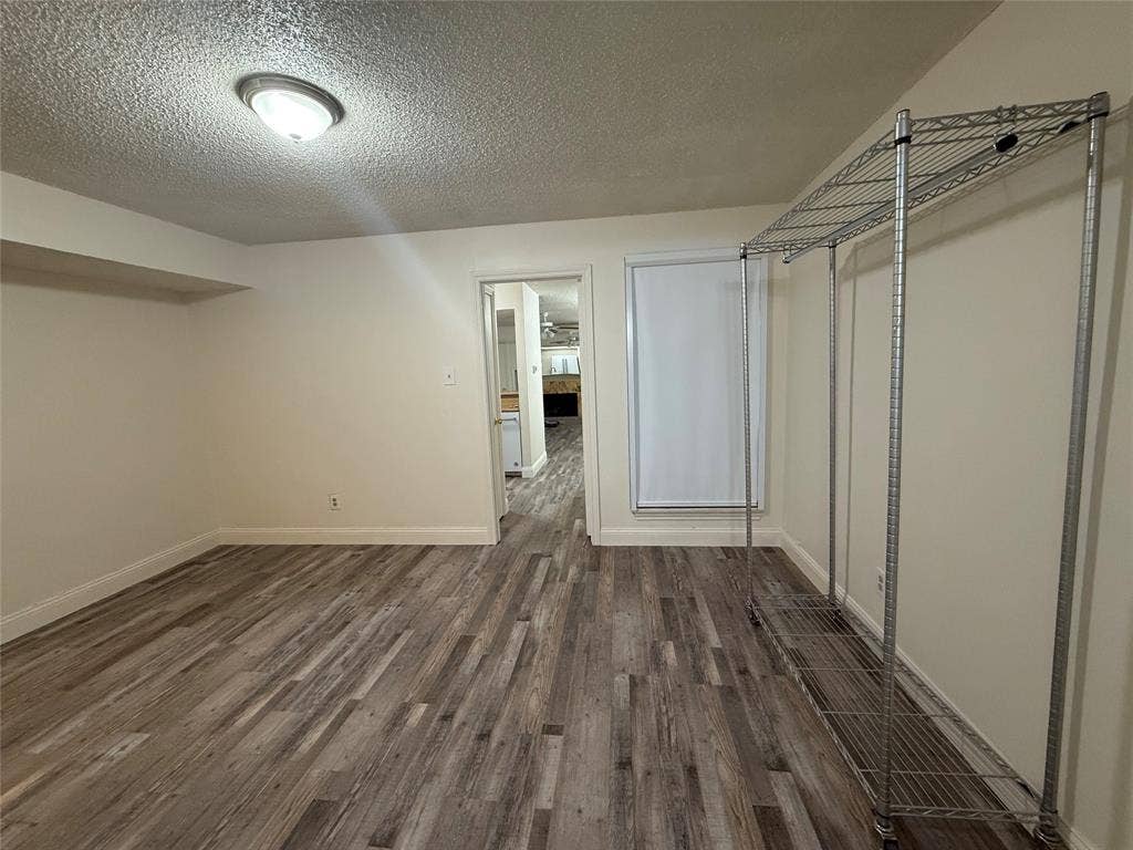 Bedroom with walk in closet and en suite bath. UBlockout electric remote controlled shade and luxury vinyl plank flooring.