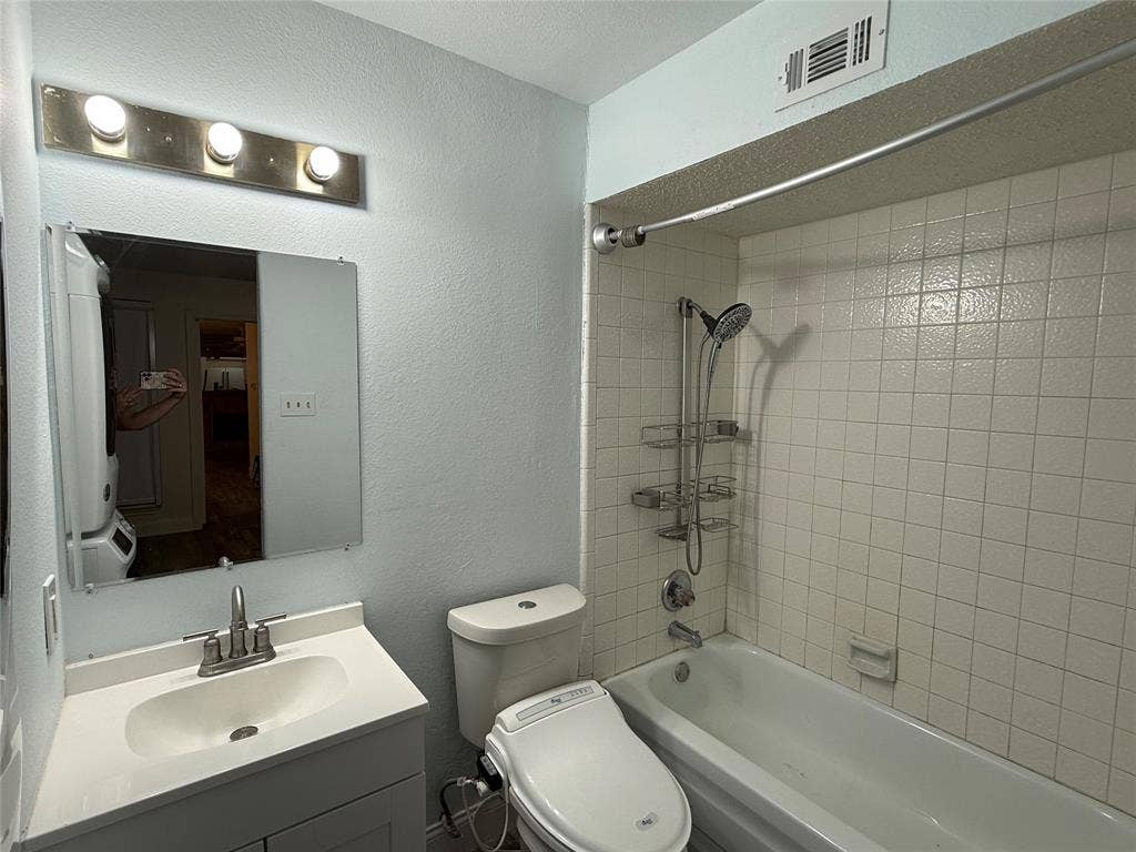Bathroom with tub shower and vanity.