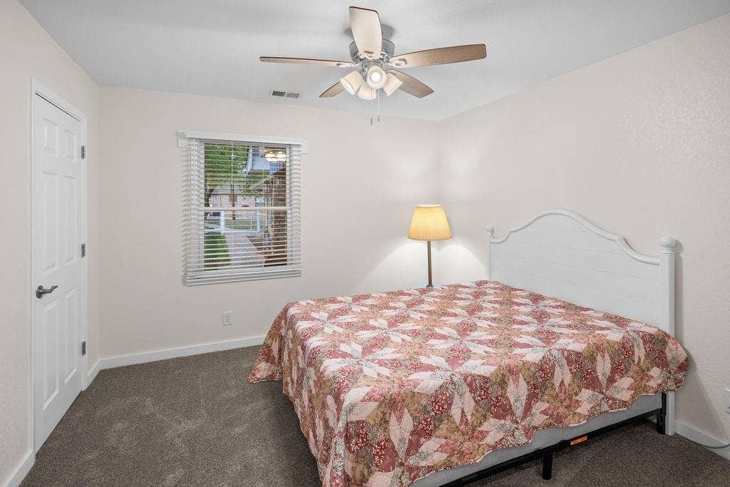 15993 Big Oak Bay Road, Tyler, TX 75707 Neutral wall tones, wall-to-wall carpeting, white paneled interior door, and a ceiling-mounted light fixture with a fan