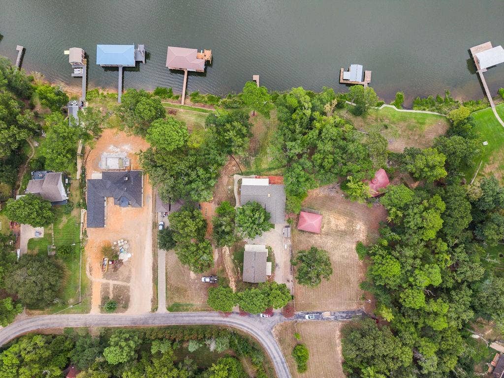 15993 Big Oak Bay Road, Tyler, TX 75707 Aerial perspective featuring deep-water shoreline, private boat dock, mature tree canopy, and expansive lot