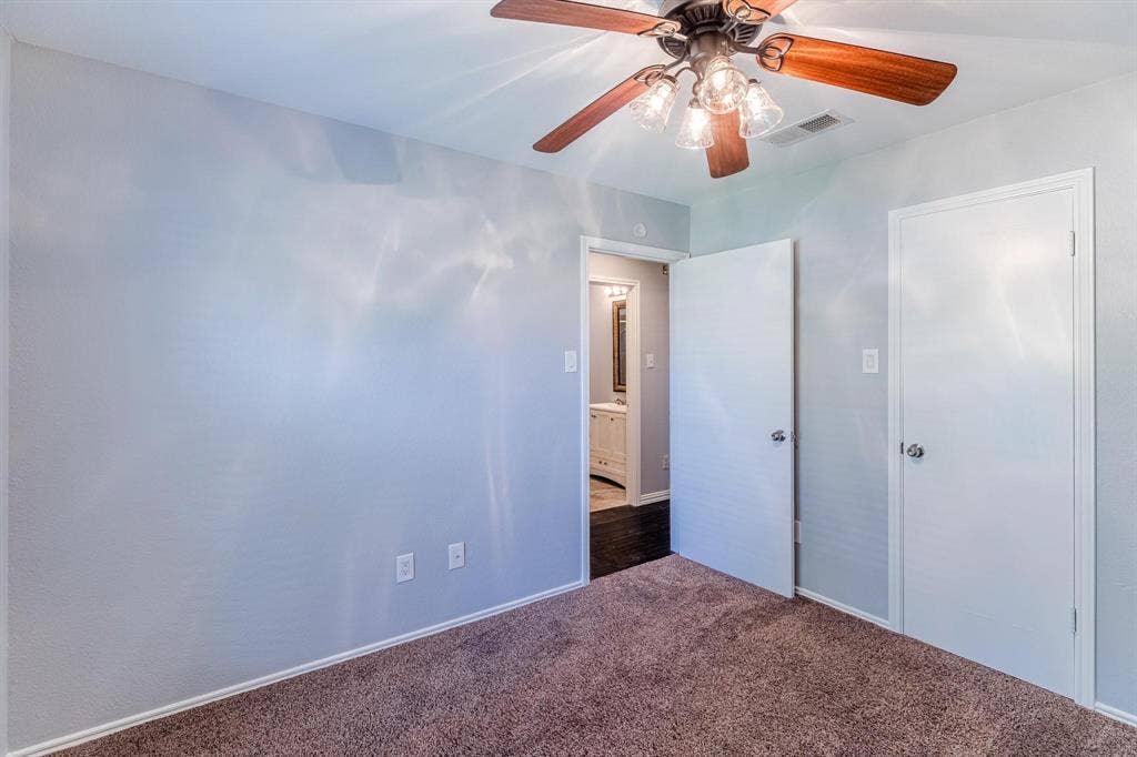 3618 Flagstone Avenue, Rowlett, TX 75088 Neutral-toned walls, ceiling fan with integrated multi-light fixture, and neutral carpeting