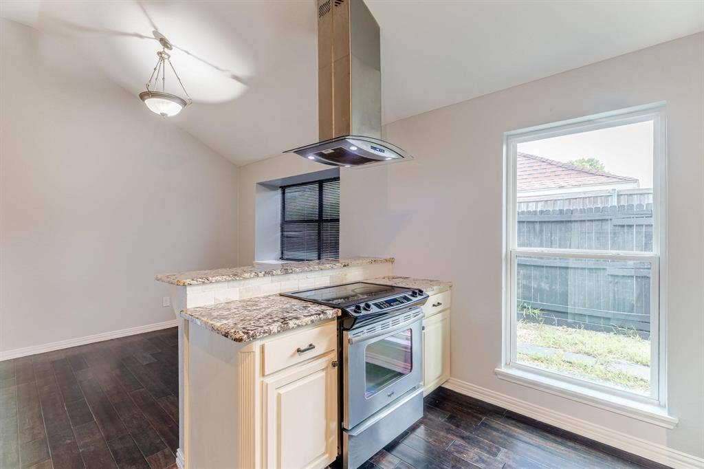 3618 Flagstone Avenue, Rowlett, TX 75088 Kitchen featuring wood-finish flooring, stone-surfaced countertops, stainless steel range, and a stainless steel chimney-style vent hood