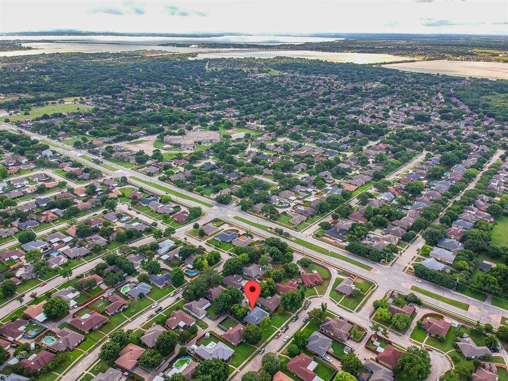 3618 Flagstone Avenue, Rowlett, TX 75088 Aerial perspective of a residential lot situated within a suburban neighborhood featuring mature trees and proximity to regional waterways