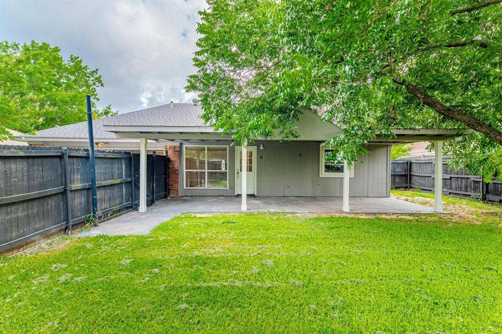 3618 Flagstone Avenue, Rowlett, TX 75088 Covered patio with concrete flooring, fenced backyard, and mature shade trees