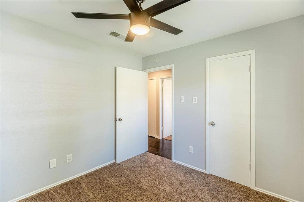 3618 Flagstone Avenue, Rowlett, TX 75088 Neutral-toned walls, high-pile carpeting, and a ceiling fan with integrated lighting