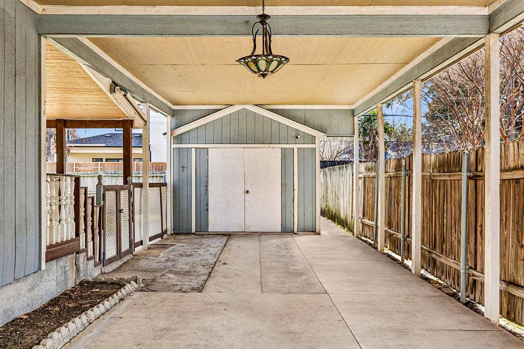 Car port covered parking with additional storage unit.