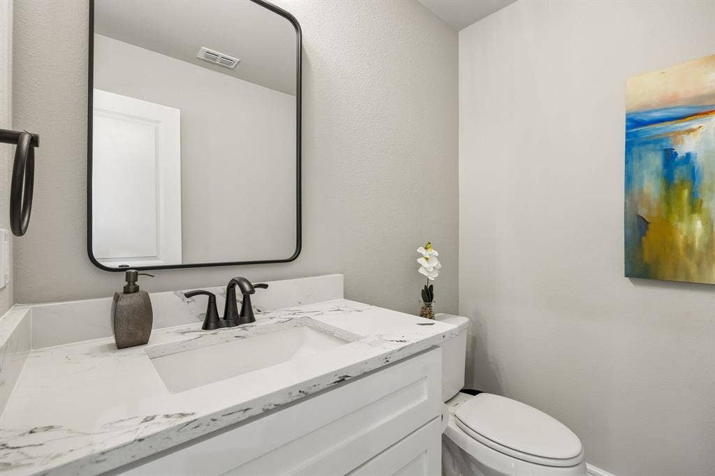 407 Frank Street, Terrell, TX 75160 407 Frank quartz countertops in half bath and framed mirror