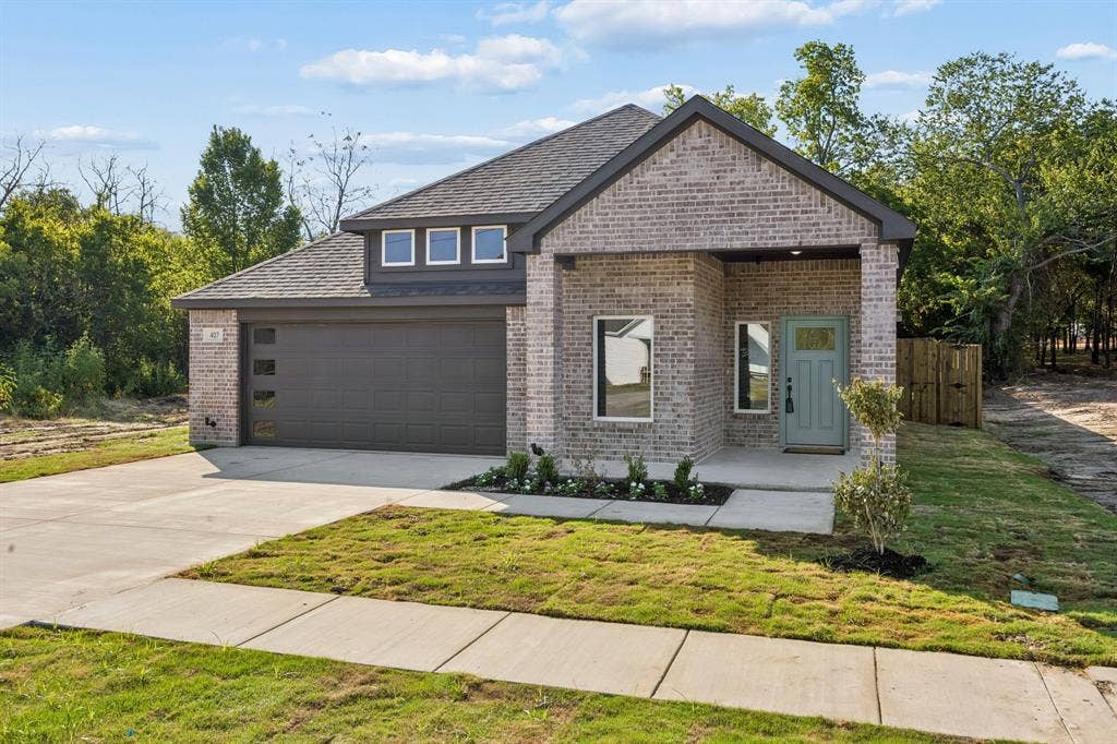 407 Frank Street, Terrell, TX 75160 407 Frank glass garage windows and fresh landscape