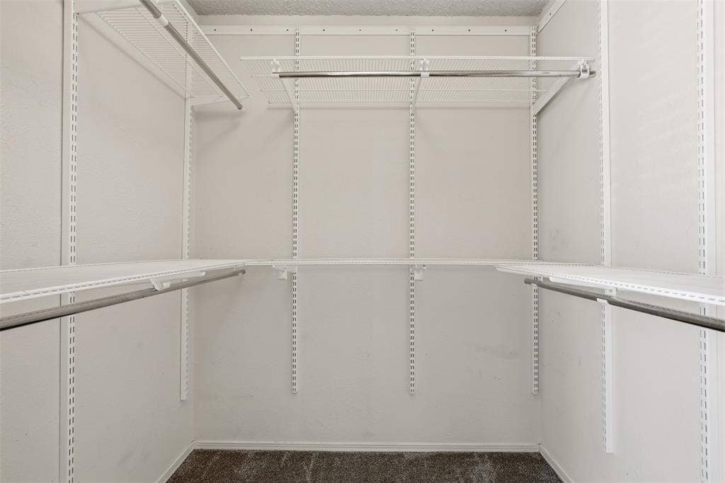14333 Preston Road, #806, Dallas, TX 75254 Walk-in storage space featuring adjustable white wire shelving and integrated metal garment rods