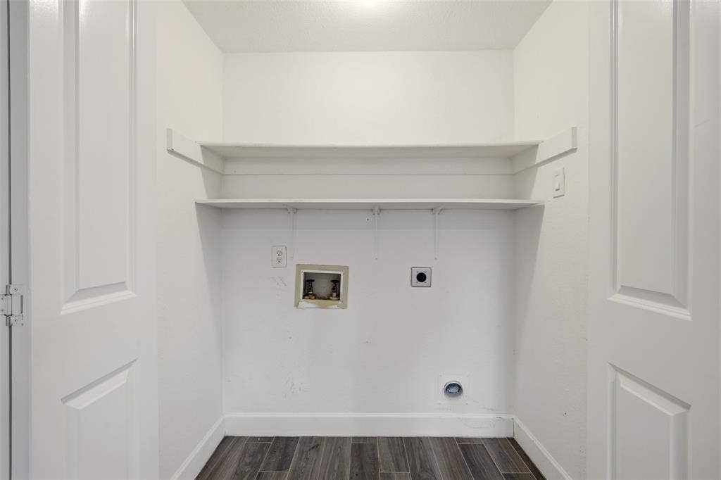 14333 Preston Road, #806, Dallas, TX 75254 Laundry alcove featuring double-door entry, wood-finish flooring, and two tiers of built-in shelving
