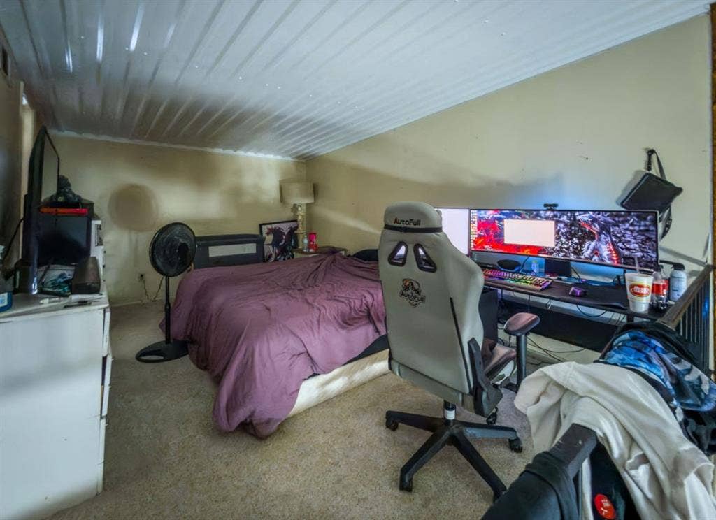 Sloped ceilings finished with white corrugated paneling and neutral wall tones
