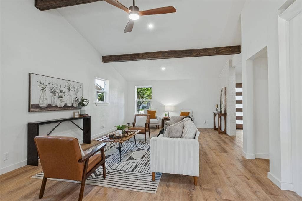 828 Melrose Drive, Richardson, TX 75234 Vaulted ceiling featuring exposed timber beams, wood-finish flooring, and a ceiling fan with integrated lighting