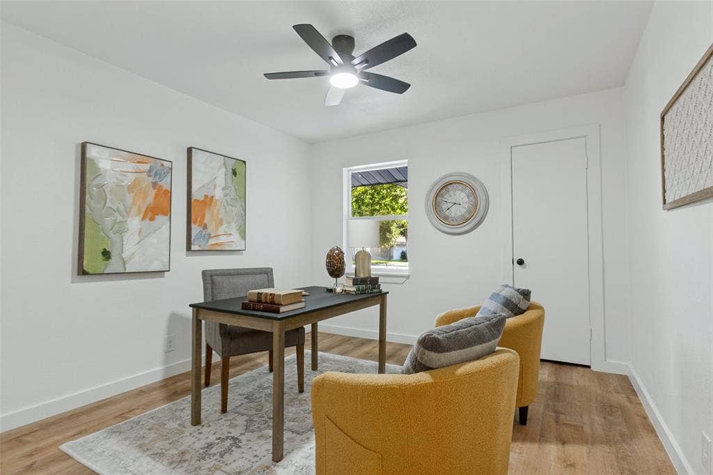 828 Melrose Drive, Richardson, TX 75234 Interior room featuring wood-finish flooring, a neutral color palette, a single-hung window, and a multi-blade ceiling fan with integrated lighting