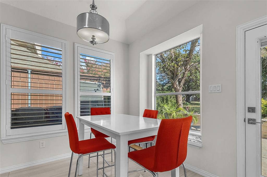 Breakfast nook with bay window, plantation shutters, and yard door — 5804 Lafayette Dr, Frisco