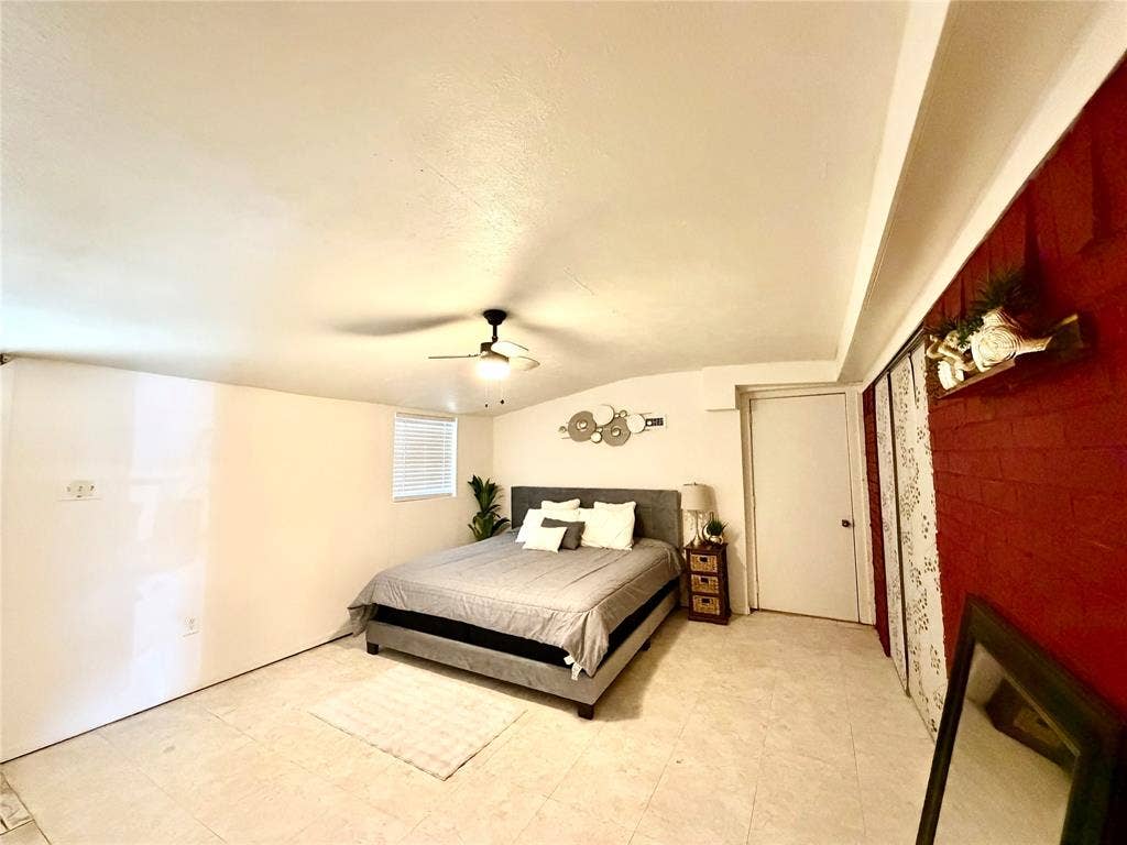 817 Colchester Drive, Mesquite, TX 75149 Spacious interior room featuring light-colored flooring, a ceiling fan with integrated lighting, and a window with horizontal blinds