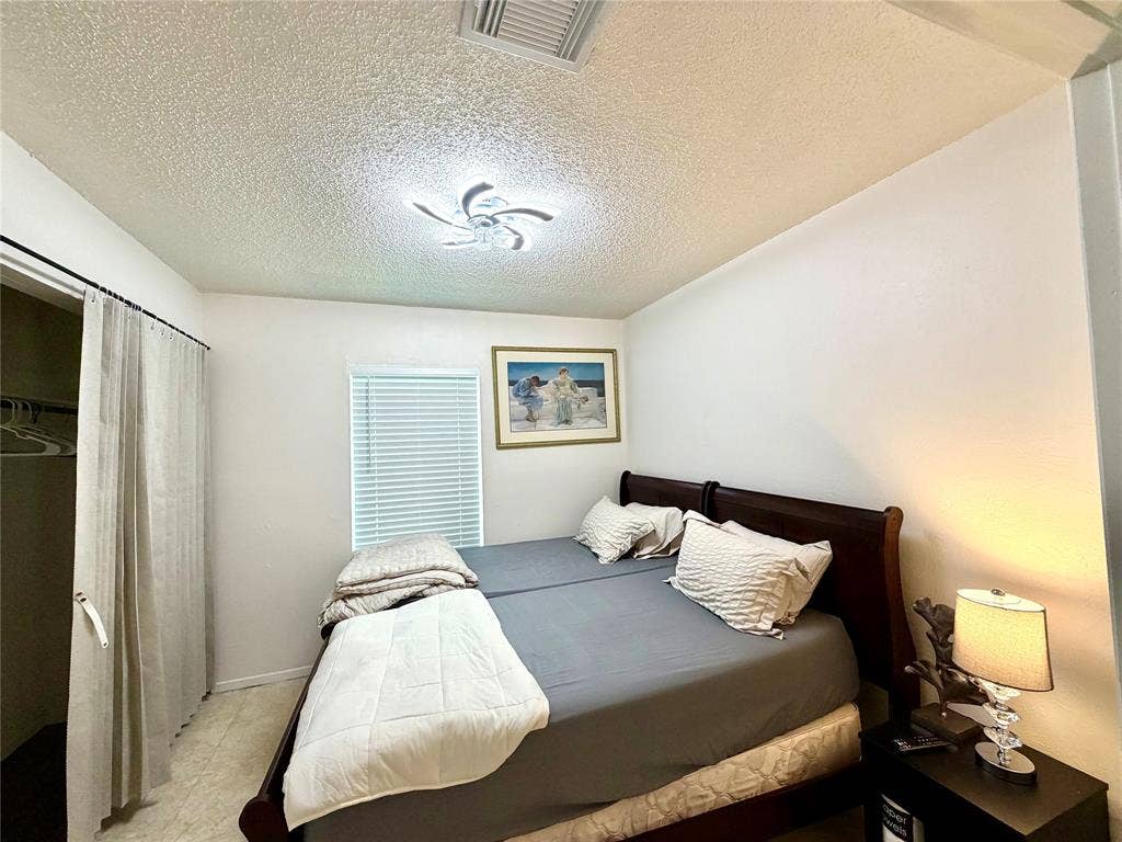 817 Colchester Drive, Mesquite, TX 75149 Bedroom featuring a window with horizontal blinds, overhead flush-mount lighting, and a closet with a curtain closure