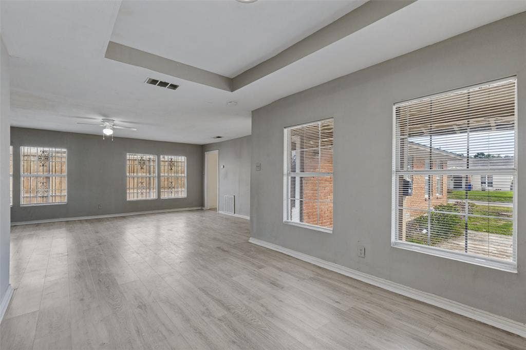 6719 Kenwell Street, Dallas, TX 75209 Tray ceiling, wood-finish flooring, multi-pane windows, and ceiling fan with integrated lighting