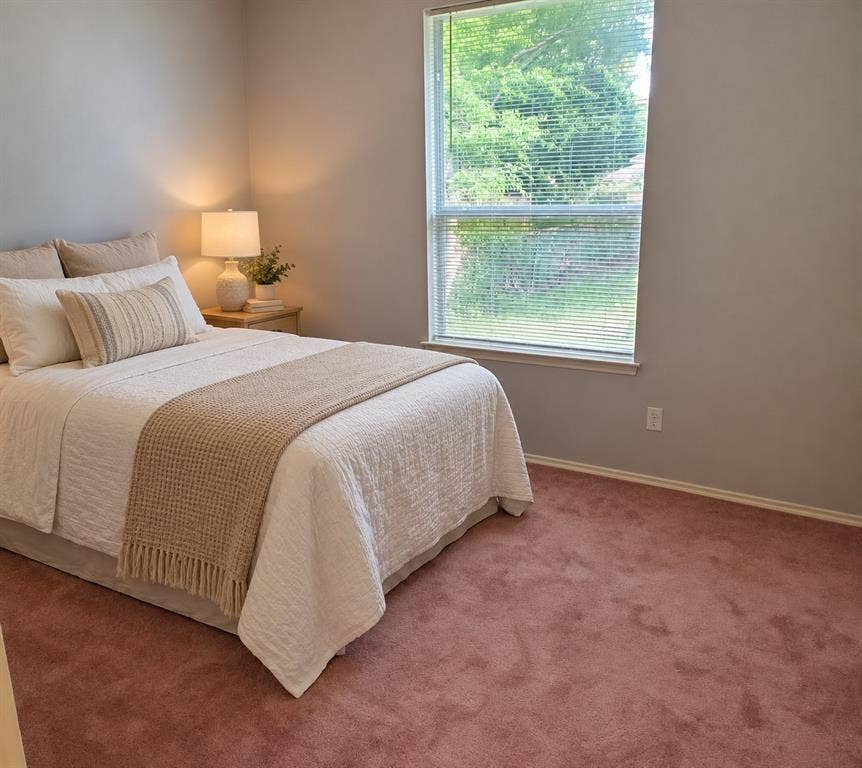 462 Pittman Street, Richardson, TX 75081 Neutral wall tones, wall-to-wall carpeting, and a single-pane window with horizontal blinds