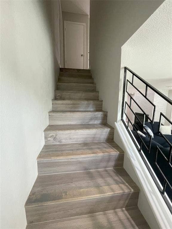 Stairs featuring wood-type flooring