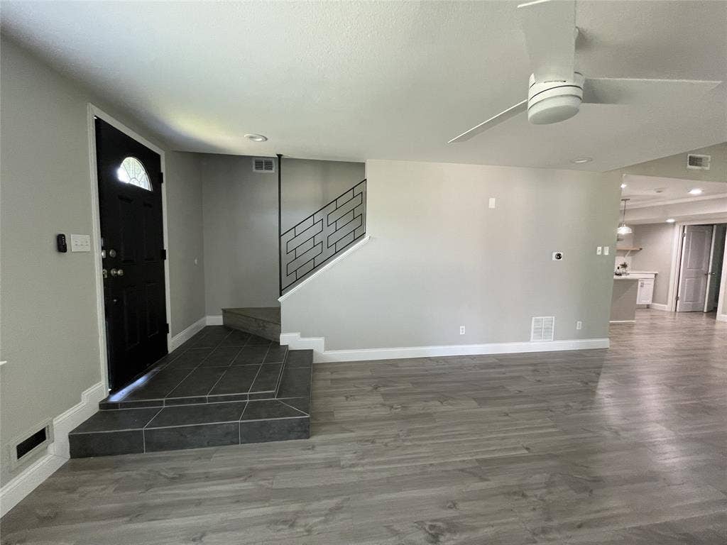 Entryway featuring dark wood-type flooring and ceiling fan