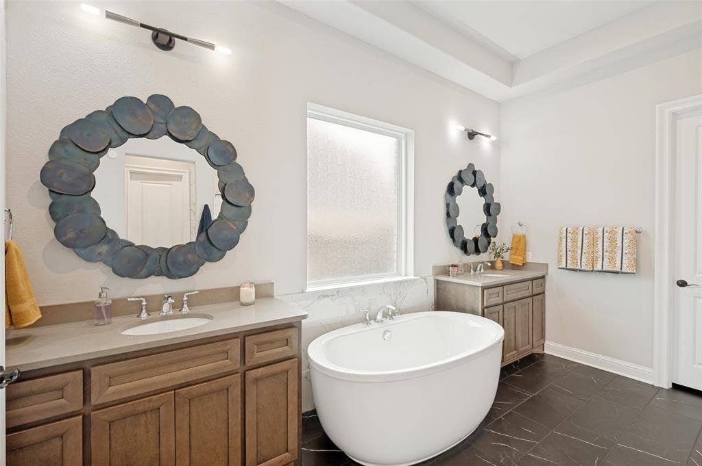 1730 Cottonwood Trail, Prosper, TX 75078 Freestanding soaking tub with dual vanity sinks in this spa-like primary ensuite.