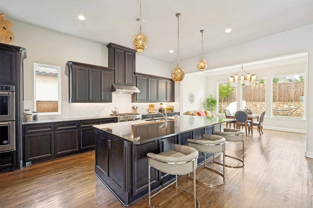 1730 Cottonwood Trail, Prosper, TX 75078 Expansive chef's kitchen features commercial 6 burner cooktop, double ovens plus an abundance of countertop and cabinet space - plus wait until you see this pantry!