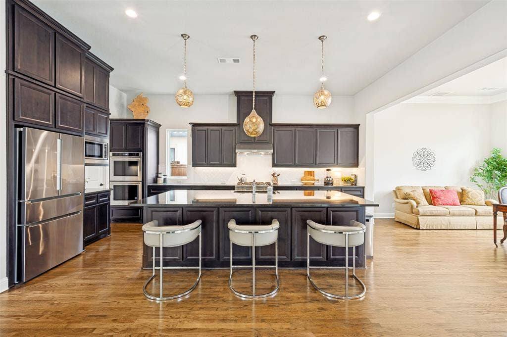 1730 Cottonwood Trail, Prosper, TX 75078 Spacious kitchen and open spacious dining area with backyard views is an ideal plan.
