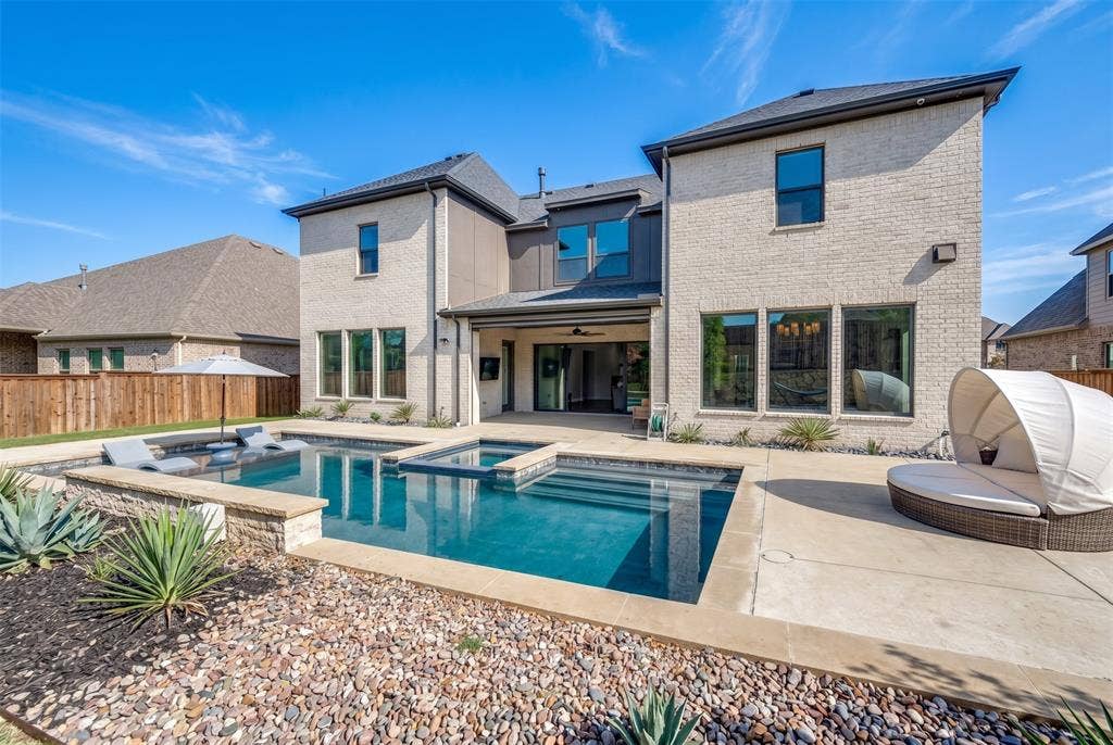 1730 Cottonwood Trail, Prosper, TX 75078 Contemporary brick exterior with a multi-level pool, integrated spa, and expansive concrete patio