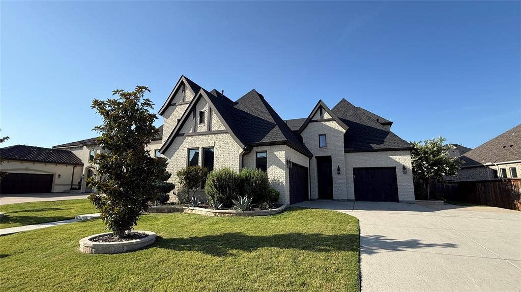 1730 Cottonwood Trail, Prosper, TX 75078 East side view of 2 car garage and separate single garage as well as a separate entrance to the private courtyard.