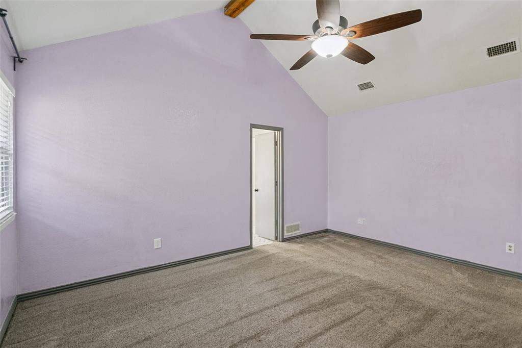 8820 Woodstream Drive, Frisco, TX 75034 Vaulted ceilings featuring a central wooden beam, neutral wall finish, wall-to-wall carpeting, and an integrated ceiling fan with light fixture
