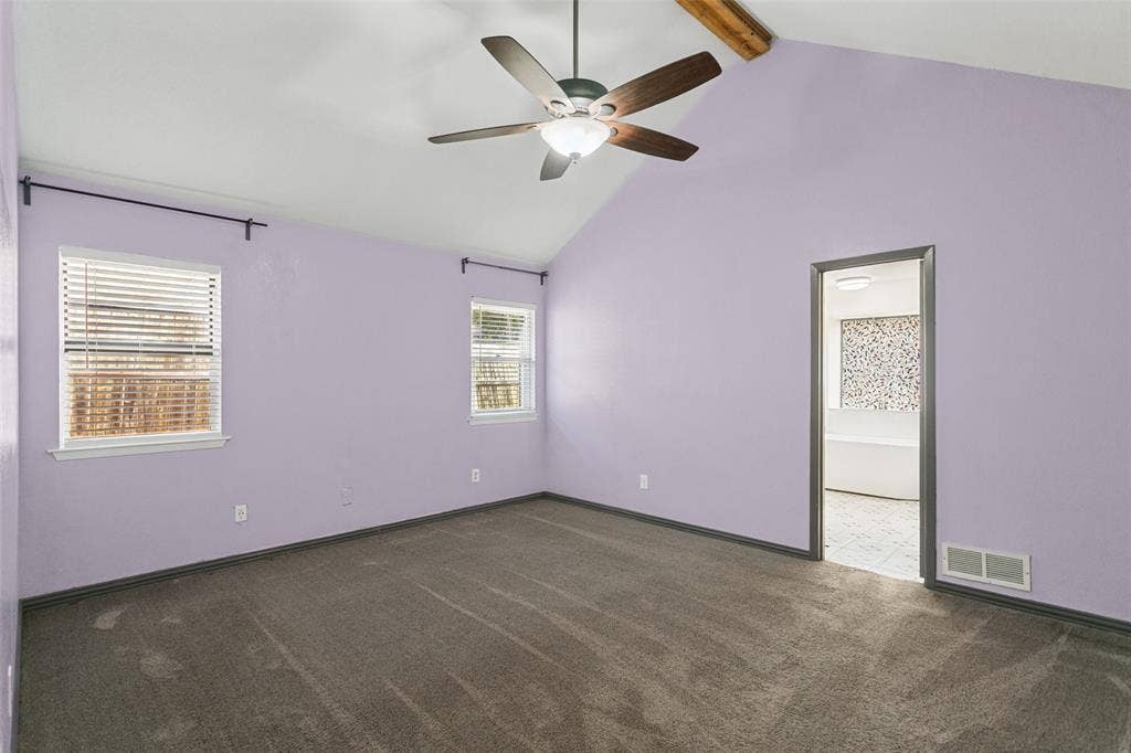 8820 Woodstream Drive, Frisco, TX 75034 Vaulted ceiling featuring a natural wood-finish beam, carpeted flooring, and a central ceiling fan with an integrated light fixture